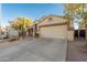 Charming single-story home with a two-car garage, desert landscaping, and a well-maintained lawn at 505 W Wayland Dr, Phoenix, AZ 85041