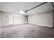 Clean, empty garage features a roll up door, side door and hot water heater at 505 W Wayland Dr, Phoenix, AZ 85041