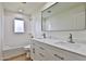 Modern bathroom with white vanity, quartz countertop, and double sinks at 523 S Spencer St, Mesa, AZ 85204