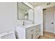 Updated bathroom featuring a double vanity, quartz countertop, and large mirror at 523 S Spencer St, Mesa, AZ 85204