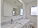 Modern bathroom with double vanity, marble countertops and a toilet at 523 S Spencer St, Mesa, AZ 85204