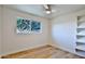 Bright bedroom with large window, ceiling fan and built-in shelving at 523 S Spencer St, Mesa, AZ 85204