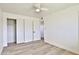 Bedroom with light flooring, ceiling fan, closet, and door at 523 S Spencer St, Mesa, AZ 85204