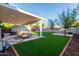 Artificial turf backyard with covered patio and firepit at 533 W Oregon Ave, Phoenix, AZ 85013