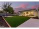 Expansive backyard with grassy lawn, patio, and privacy wall at 533 W Oregon Ave, Phoenix, AZ 85013