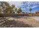 Spacious backyard with rock landscaping and trees at 5427 W St Kateri Dr, Laveen, AZ 85339