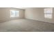 Bright and airy carpeted bedroom with two windows at 5427 W St Kateri Dr, Laveen, AZ 85339