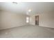 Large carpeted bedroom with window and door to another room at 5427 W St Kateri Dr, Laveen, AZ 85339