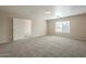 Carpeted bedroom with window and door to another room at 5427 W St Kateri Dr, Laveen, AZ 85339