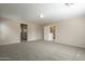 Spacious carpeted bedroom with door to hallway at 5427 W St Kateri Dr, Laveen, AZ 85339