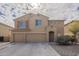 Two-story house with a three-car garage and desert landscaping at 5427 W St Kateri Dr, Laveen, AZ 85339