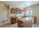 Kitchen boasts wood cabinets, an island, and a microwave at 5427 W St Kateri Dr, Laveen, AZ 85339