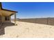 Sandy backyard with covered patio and block wall at 5509 N 193Rd Ave, Litchfield Park, AZ 85340