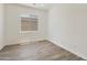 Bright bedroom with wood-look tile flooring and large window at 5509 N 193Rd Ave, Litchfield Park, AZ 85340