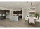 Modern kitchen with dark cabinets, white countertops, and island at 5509 N 193Rd Ave, Litchfield Park, AZ 85340