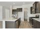 Modern kitchen with dark cabinets, white countertops, and island at 5509 N 193Rd Ave, Litchfield Park, AZ 85340