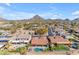 Aerial view of a house with a pool, and mountain views at 6107 W Hedgehog Pl, Phoenix, AZ 85083