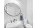 Bathroom with toilet, sink, and round mirror at 6107 W Hedgehog Pl, Phoenix, AZ 85083