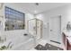 Bathroom with soaking tub, glass shower, and a large window at 6107 W Hedgehog Pl, Phoenix, AZ 85083