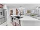 Modern kitchen island with farmhouse sink and breakfast bar seating at 6107 W Hedgehog Pl, Phoenix, AZ 85083