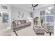 Cozy living room with gray sofa, comfortable armchair, and built-in shelving at 6107 W Hedgehog Pl, Phoenix, AZ 85083