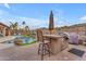 Outdoor kitchen with a built-in grill and bar seating at 6107 W Hedgehog Pl, Phoenix, AZ 85083