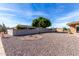 Landscaped backyard with gravel and a small circular garden at 6457 E Dallas St, Mesa, AZ 85205