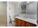 Clean bathroom, featuring a shower, toilet and vanity with marble top at 6457 E Dallas St, Mesa, AZ 85205