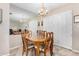 Dining room with a wood table, six chairs, and a chandelier at 6457 E Dallas St, Mesa, AZ 85205