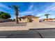 Ranch home with two-car garage and palm trees at 6457 E Dallas St, Mesa, AZ 85205