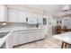 Bright eat-in kitchen with white cabinets and tile floors at 6457 E Dallas St, Mesa, AZ 85205