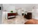 Living room with tiled floors, wooden furniture, and a view of dining area at 6457 E Dallas St, Mesa, AZ 85205