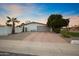 House exterior with gray garage door and gravel driveway at 6547 E Eugie Ter, Scottsdale, AZ 85254