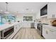 L-shaped kitchen with white cabinets, stainless steel appliances, and a large island at 6547 E Eugie Ter, Scottsdale, AZ 85254