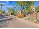 Elegant gated entrance to Gainey Club Drive at Gainey Ranch featuring lush landscaping and mature trees at 7400 E Gainey Club Dr # 222, Scottsdale, AZ 85258