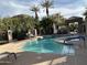 Refreshing community pool with palm trees and shaded seating areas at 7400 E Gainey Club Dr # 222, Scottsdale, AZ 85258