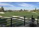 Scenic golf course view from the balcony features lush greens and sand traps under a partly cloudy blue sky at 7400 E Gainey Club Dr # 222, Scottsdale, AZ 85258