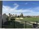 Balcony view showcases a beautiful golf course with blue skies, mature trees, and luxury homes in the distance at 7400 E Gainey Club Dr # 222, Scottsdale, AZ 85258