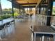 Outdoor dining area with tables, chairs, barstools, and views of the community pool at 7400 E Gainey Club Dr # 222, Scottsdale, AZ 85258