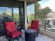 Charming patio with red seating, a modern fire pit, and a beautiful golf course backdrop at 7400 E Gainey Club Dr # 222, Scottsdale, AZ 85258