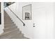 Interior shot of a staircase with a black handrail and stylish, light-colored carpet at 7400 E Gainey Club Dr # 222, Scottsdale, AZ 85258