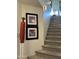 Carpeted stairway with decorative art creates an inviting and stylish transition to the upper level of the home at 7400 E Gainey Club Dr # 222, Scottsdale, AZ 85258