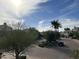 Neighborhood street view with palm trees, bushes, houses, and a sunny sky at 7400 E Gainey Club Dr # 222, Scottsdale, AZ 85258