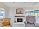 Cozy living room with fireplace, comfortable chairs, and natural light at 745 Leisure World --, Mesa, AZ 85206