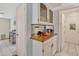 Wet bar with wood countertop and glass-front cabinets at 745 Leisure World --, Mesa, AZ 85206