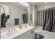 Clean bathroom with double vanity, gray tile, and a bathtub at 7460 E Via De Luna Dr, Scottsdale, AZ 85255