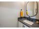 Modern bathroom with gray vanity, white cabinets, and updated fixtures at 7460 E Via De Luna Dr, Scottsdale, AZ 85255