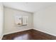 Bright bedroom with dark hardwood floors and large window at 750 E Northern Ave # 1089, Phoenix, AZ 85020