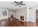 Living room with hardwood floors, fireplace, and ceiling fan at 750 E Northern Ave # 1089, Phoenix, AZ 85020