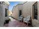 Brick patio with two chairs and a house entrance at 8100 E Camelback Rd # 14, Scottsdale, AZ 85251